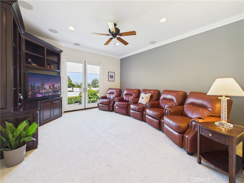 1662 Cherokee Road Corona, CA 92881 - Photo 24 of 60 a living room with furniture a flat screen tv and a fireplace