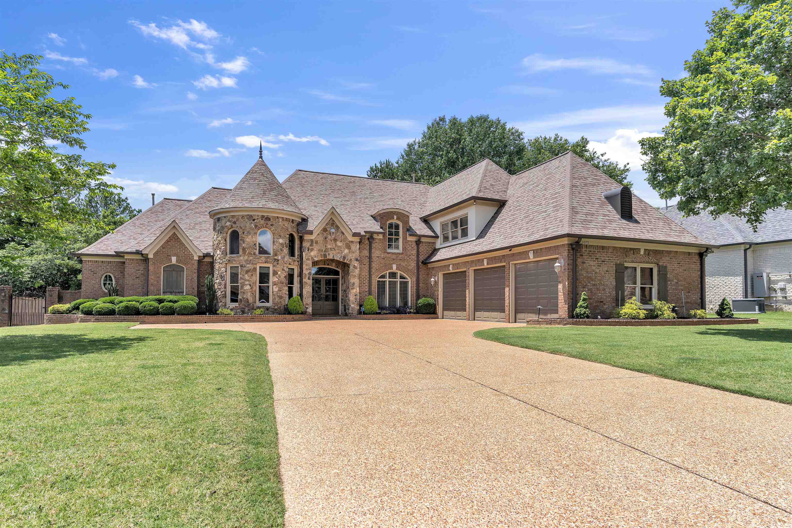 1075 Summer Spring Road Collierville, TN 38017 - Photo 1 of 40 a front view of a house with a yard