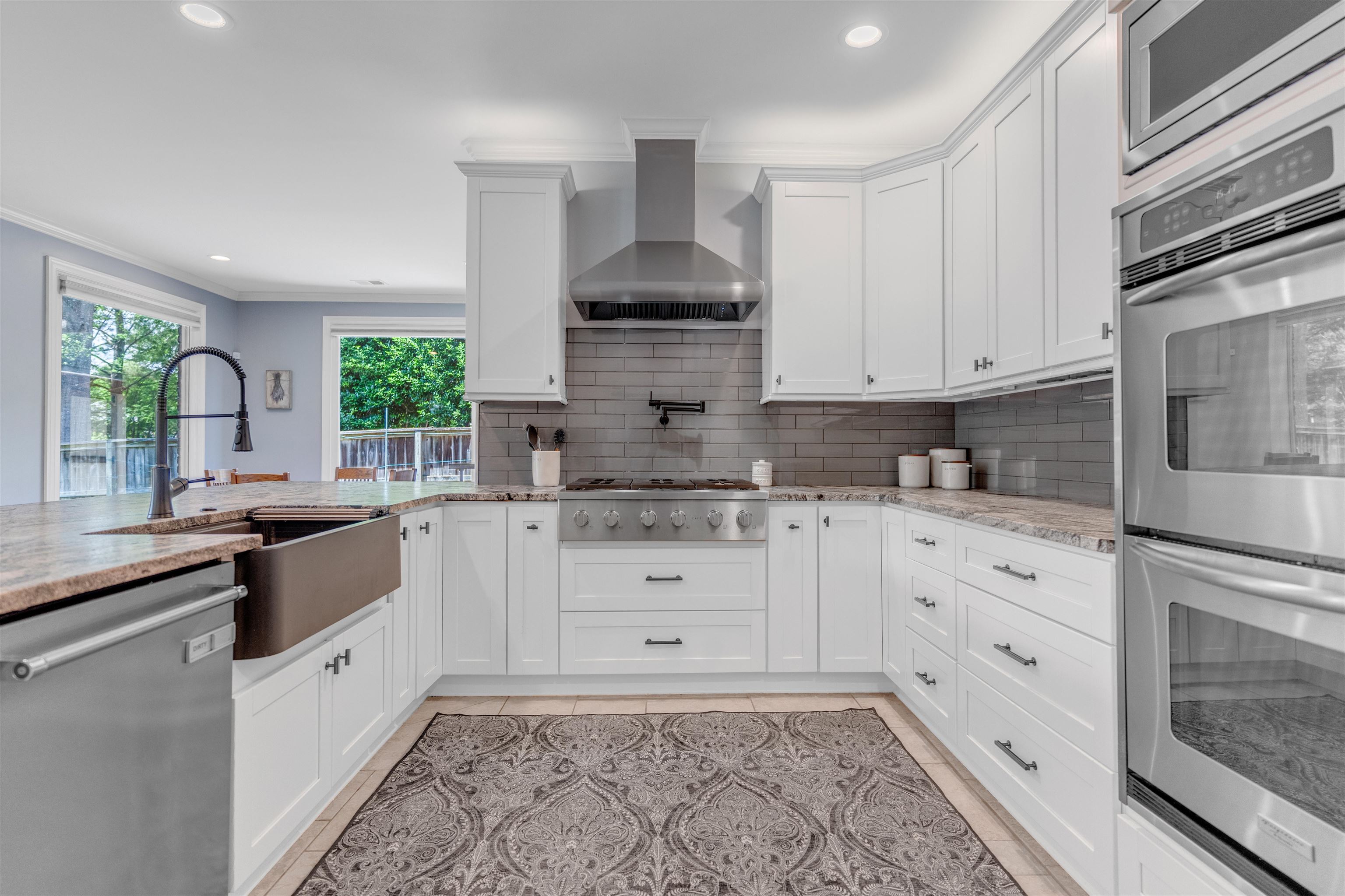 1075 Summer Spring Road Collierville, TN 38017 - Photo 11 of 40 a kitchen with granite countertop white cabinets and white appliances