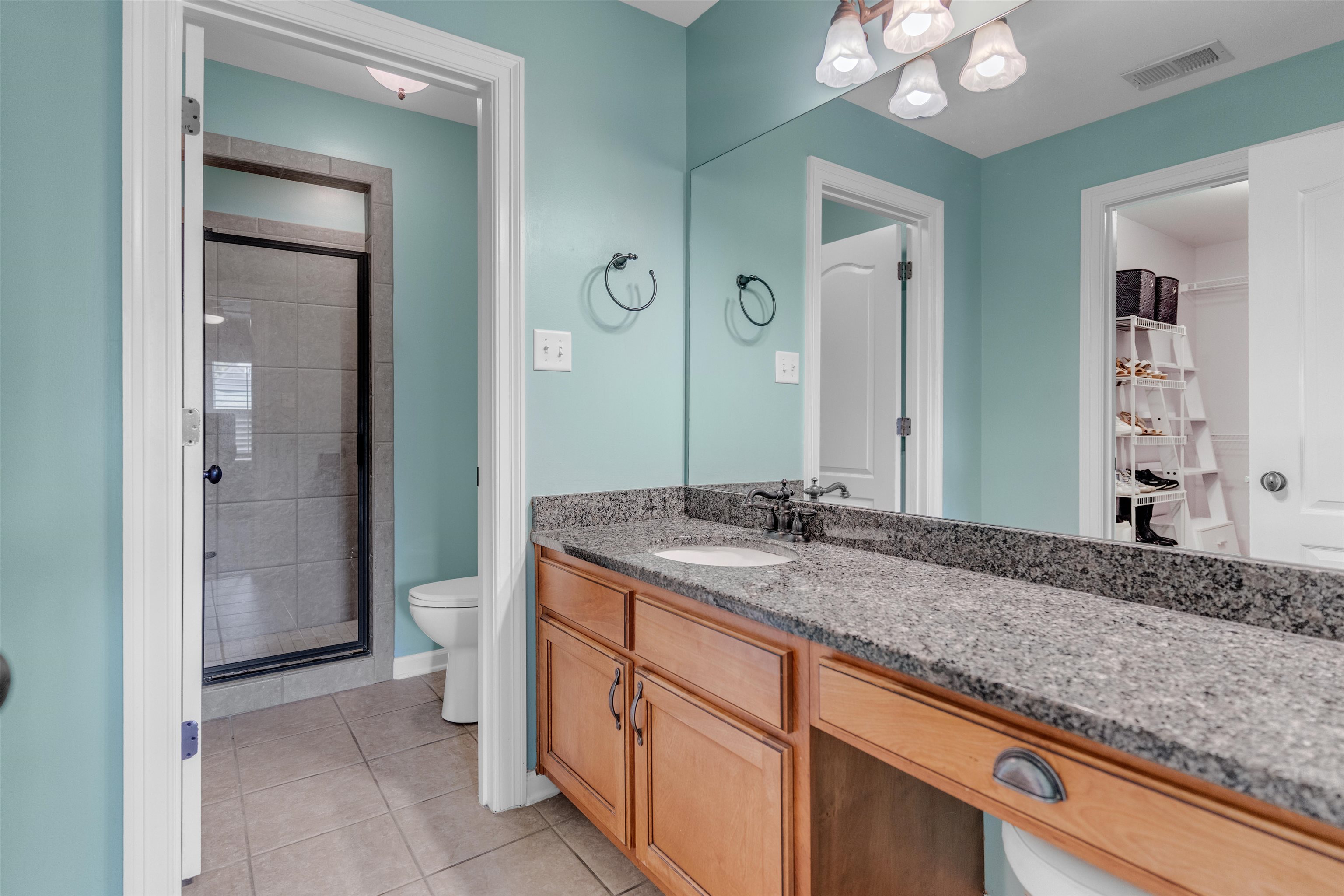 1075 Summer Spring Road Collierville, TN 38017 - Photo 28 of 40 a bathroom with a granite countertop sink and a mirror