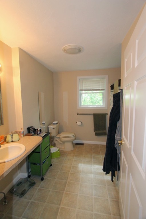 424 Putnam Hill Road Sutton, MA 01590 - Photo 8 of 12 a bathroom with a sink a toilet and mirror