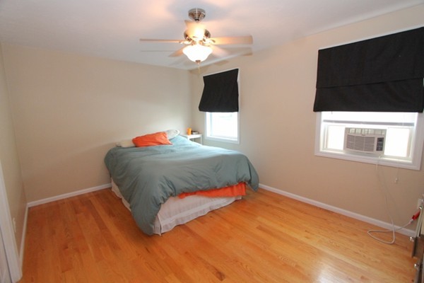 424 Putnam Hill Road Sutton, MA 01590 - Photo 9 of 12 a bedroom with a bed window and a chandelier