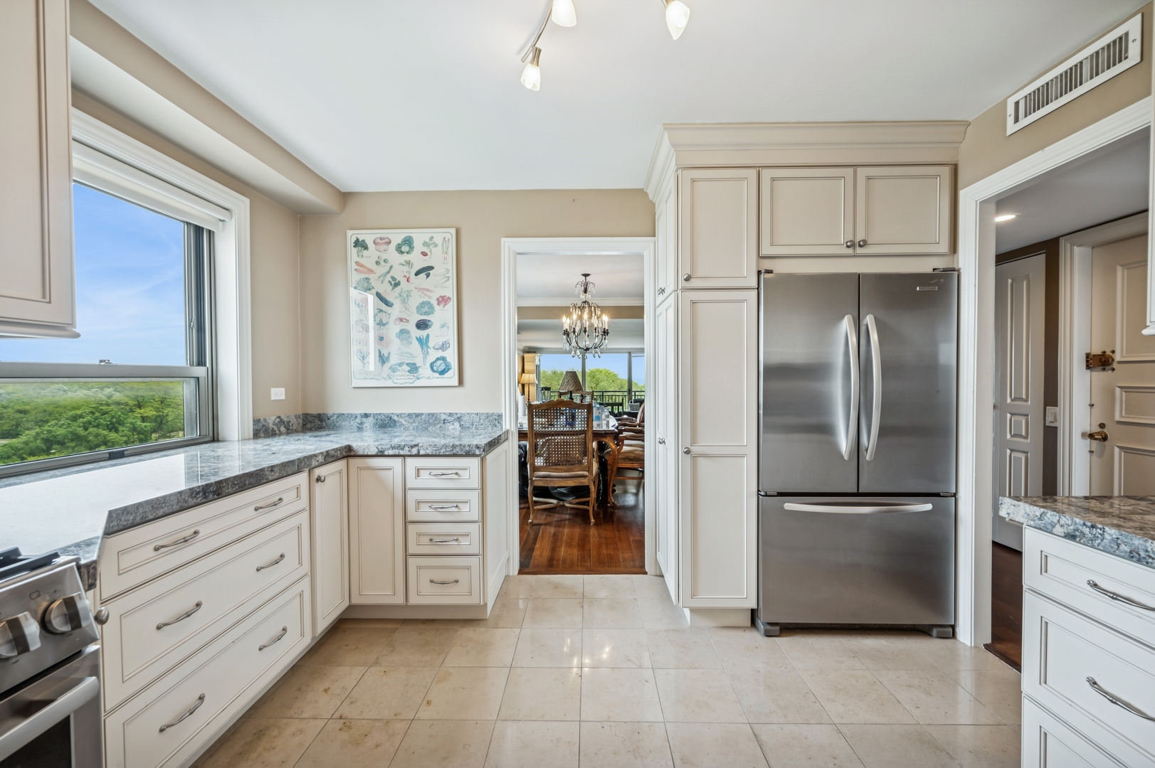 3470 North Lake Shore Drive, Unit 9BC Chicago, IL 60657 - Photo 12 of 21 a kitchen with granite countertop a refrigerator and a sink