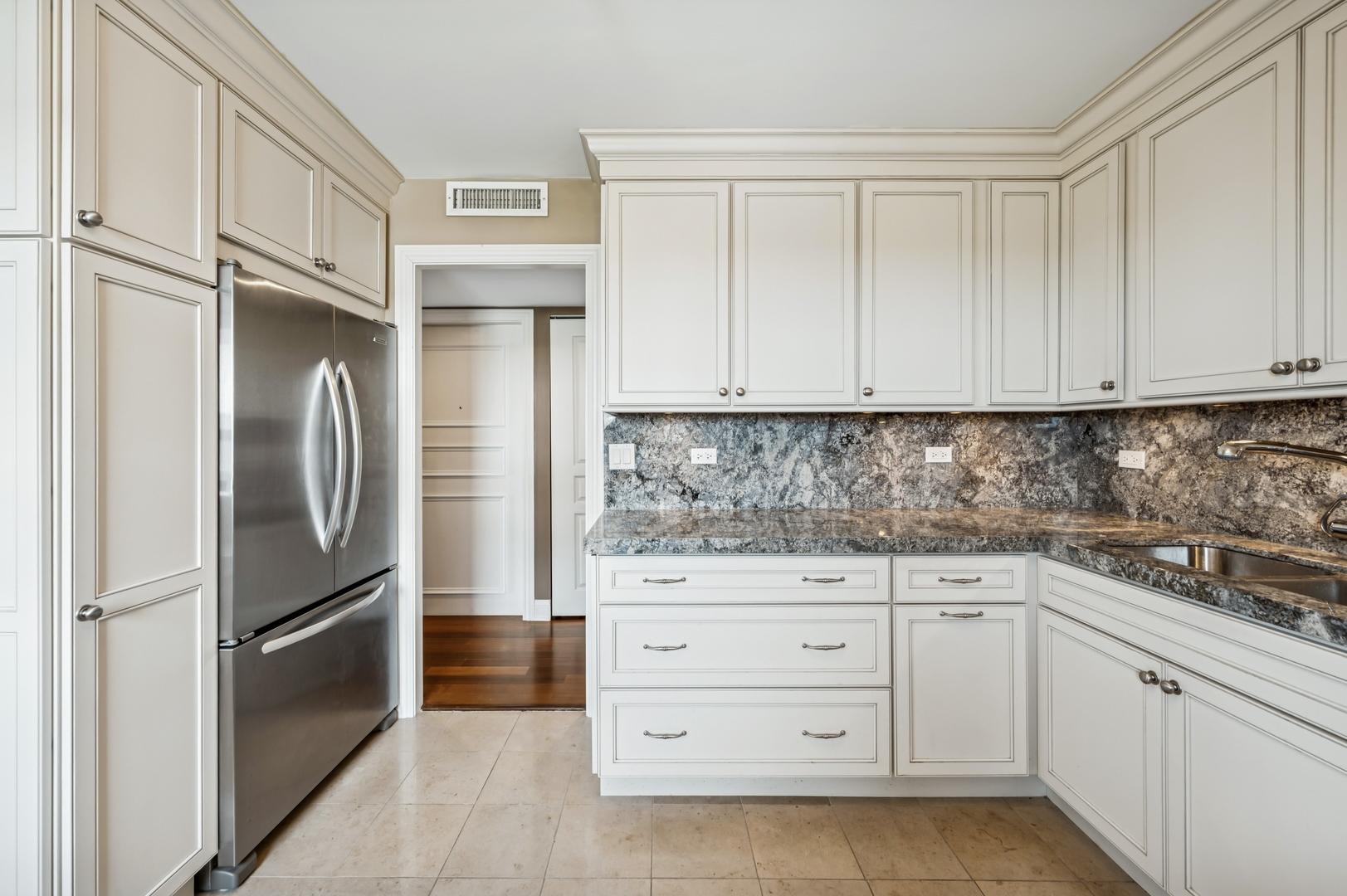 3470 North Lake Shore Drive, Unit 9BC Chicago, IL 60657 - Photo 14 of 21 a kitchen with granite countertop cabinets and stainless steel appliances