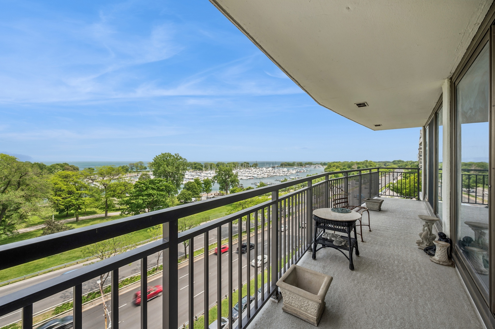 3470 North Lake Shore Drive, Unit 9BC Chicago, IL 60657 - Photo 7 of 21 a view of a chairs and table in patio with a lake view