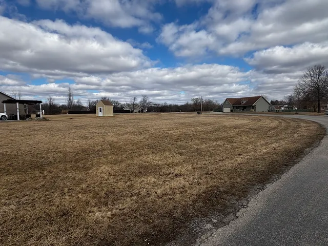 a view of a yard next to a lake