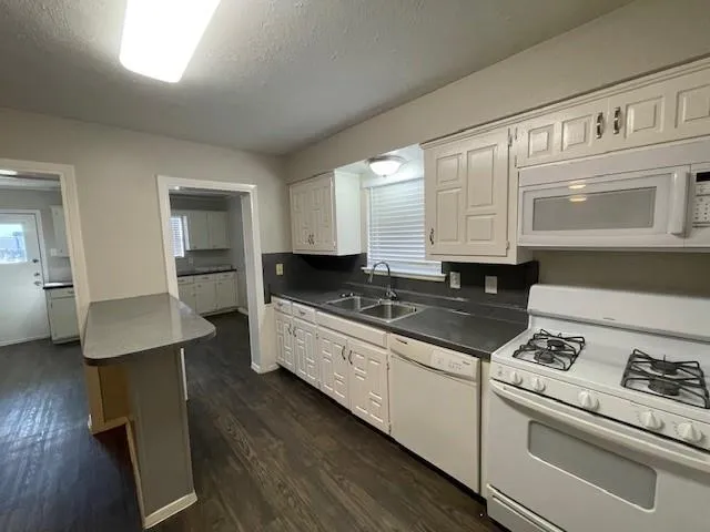 a kitchen with a stove and white cabinets