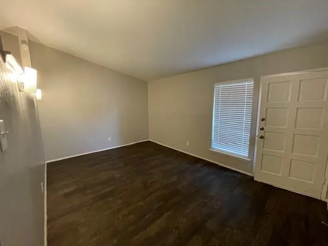 an empty room with wooden floor