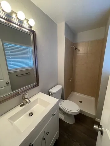a bathroom with a sink toilet and shower