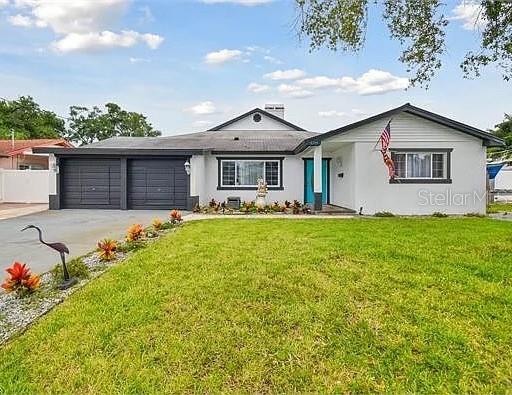 a front view of house with yard and green space