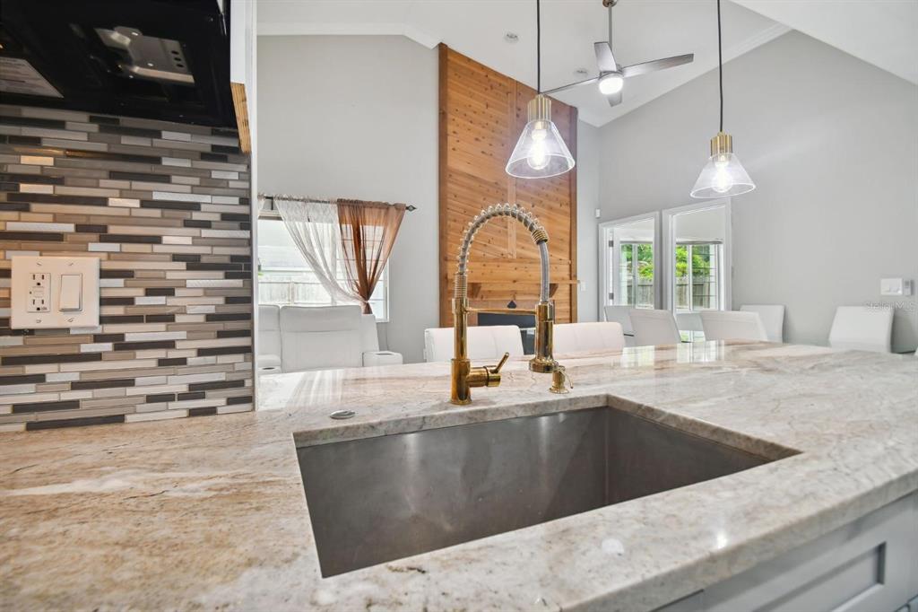 6745 Ralston Beach Circle Tampa, FL 33614 - Photo 11 of 39 a view of a kitchen with kitchen island a sink wooden floor and a large window