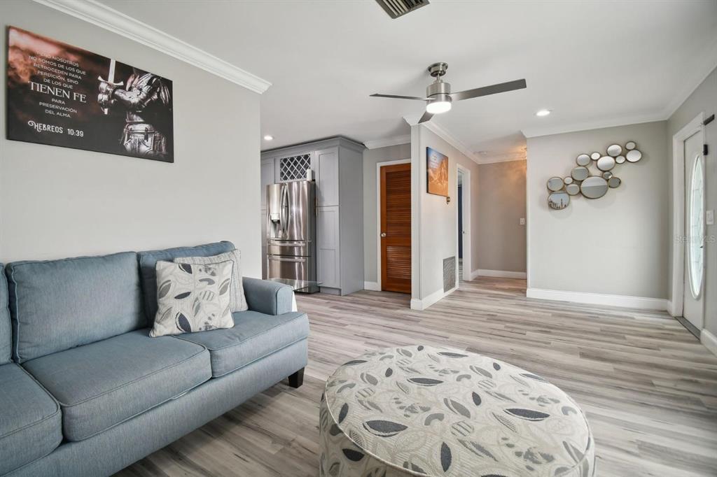 6745 Ralston Beach Circle Tampa, FL 33614 - Photo 14 of 39 a living room with furniture and wooden floor