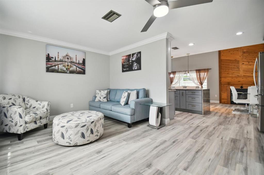 6745 Ralston Beach Circle Tampa, FL 33614 - Photo 15 of 39 a living room with furniture and a wooden floor