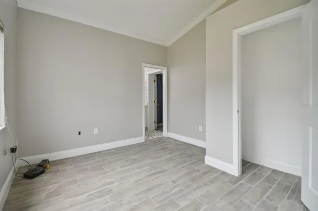 an empty room with wooden floor and closet
