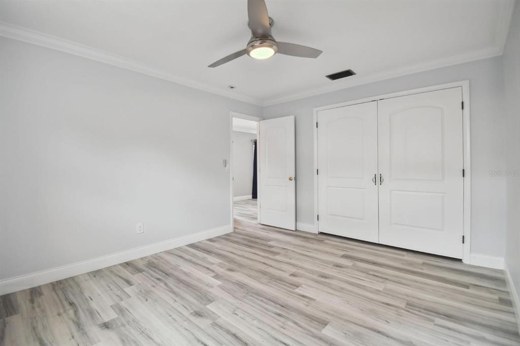 6745 Ralston Beach Circle Tampa, FL 33614 - Photo 20 of 39 a view of an empty room with wooden floor