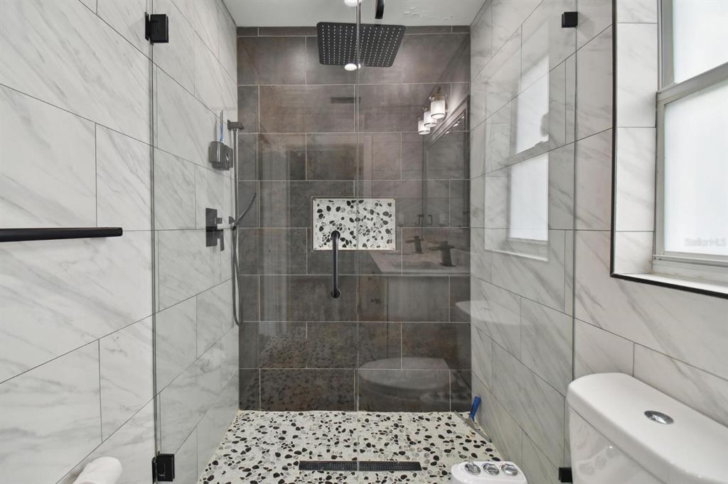 6745 Ralston Beach Circle Tampa, FL 33614 - Photo 22 of 39 a bathroom with a shower a toilet and a sink