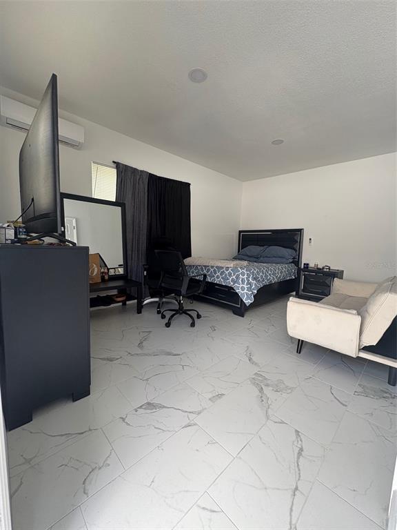 6745 Ralston Beach Circle Tampa, FL 33614 - Photo 29 of 39 a room with furniture and a flat screen tv