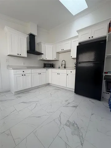 a kitchen with a refrigerator stove and cabinets