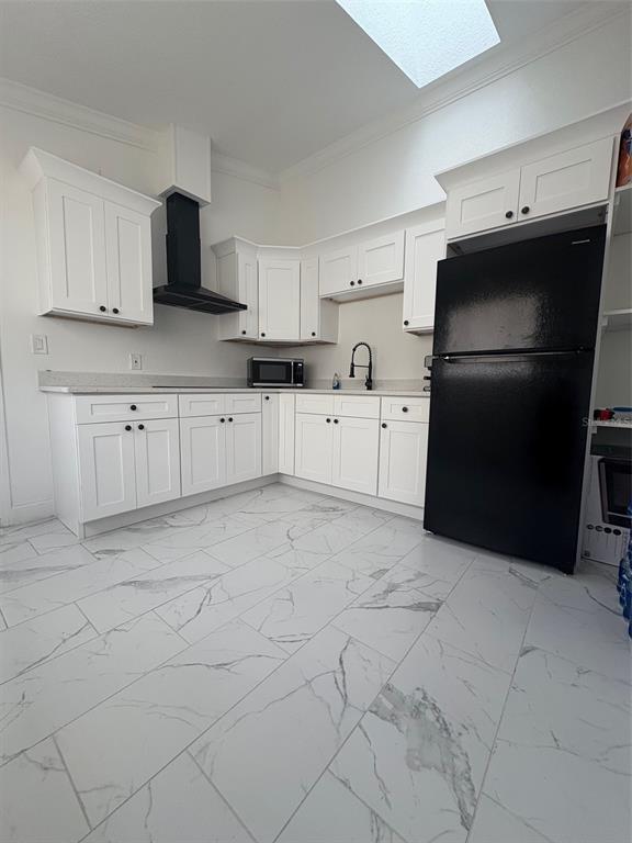 6745 Ralston Beach Circle Tampa, FL 33614 - Photo 32 of 39 a kitchen with a refrigerator stove and cabinets