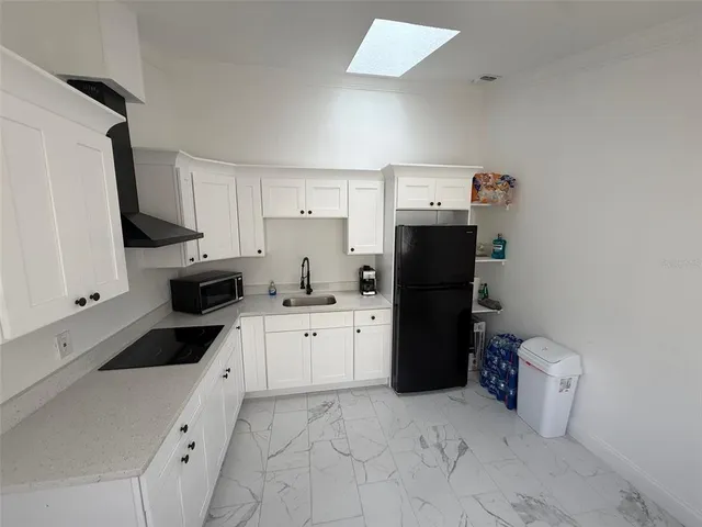 a kitchen with a sink and refrigerator
