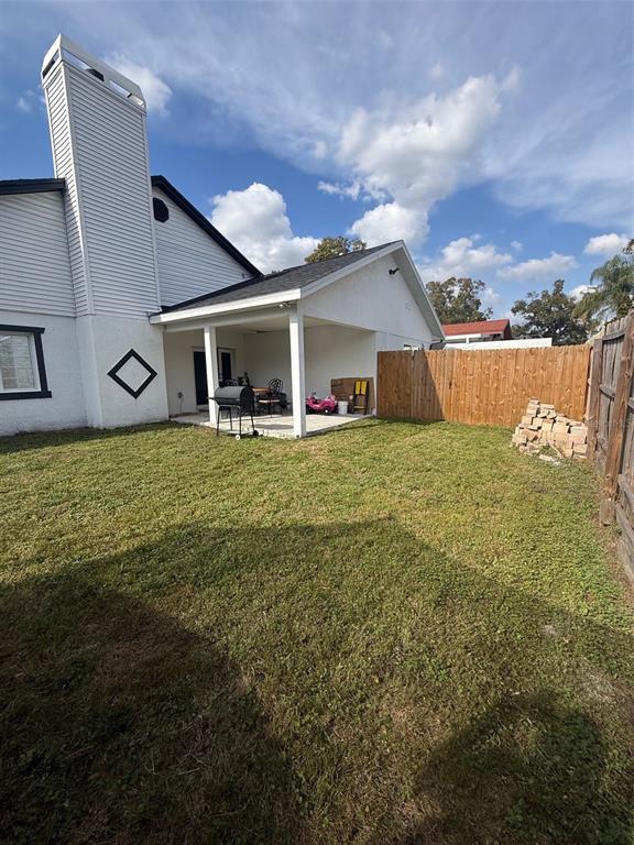 6745 Ralston Beach Circle Tampa, FL 33614 - Photo 37 of 39 a view of a house with a yard and sitting area