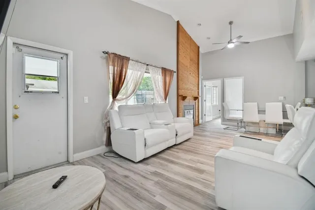 a living room with furniture and a baby crib