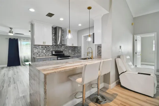 a large kitchen with a table and chairs