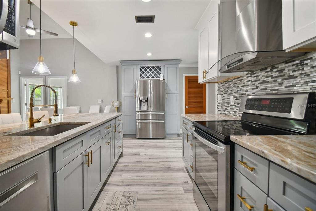 6745 Ralston Beach Circle Tampa, FL 33614 - Photo 8 of 39 a kitchen with a sink stove and cabinets