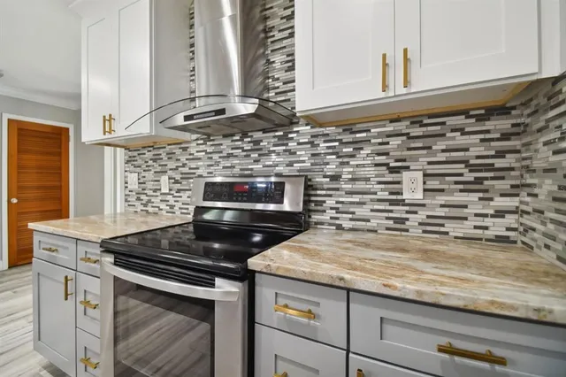 a kitchen with granite countertop a stove and a sink