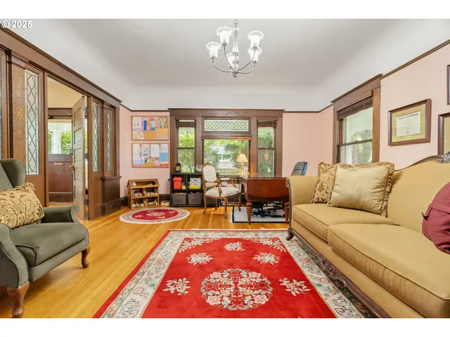 a view of a bedroom with wooden floor and windows