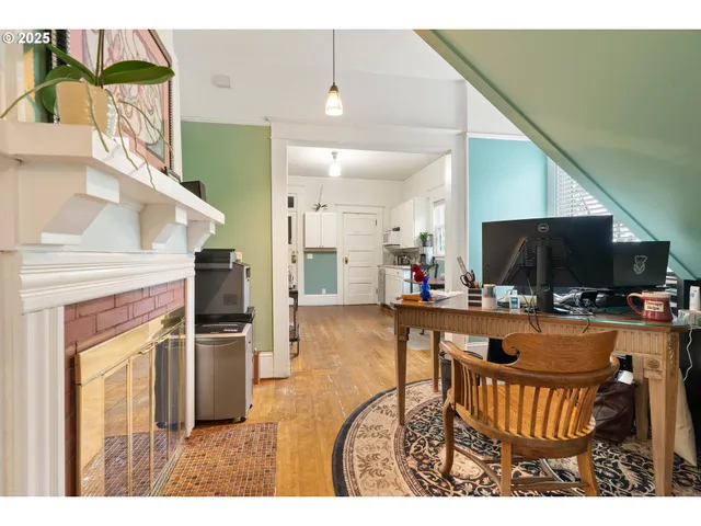 a kitchen with a table chairs refrigerator and microwave