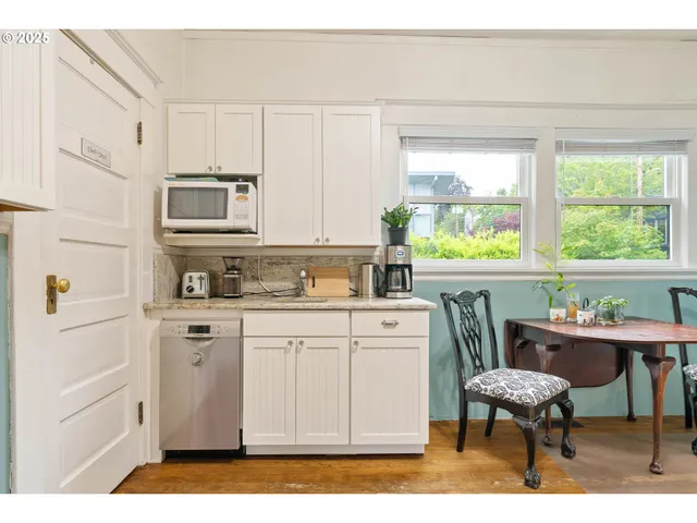a bathroom with a granite countertop toilet sink and mirror