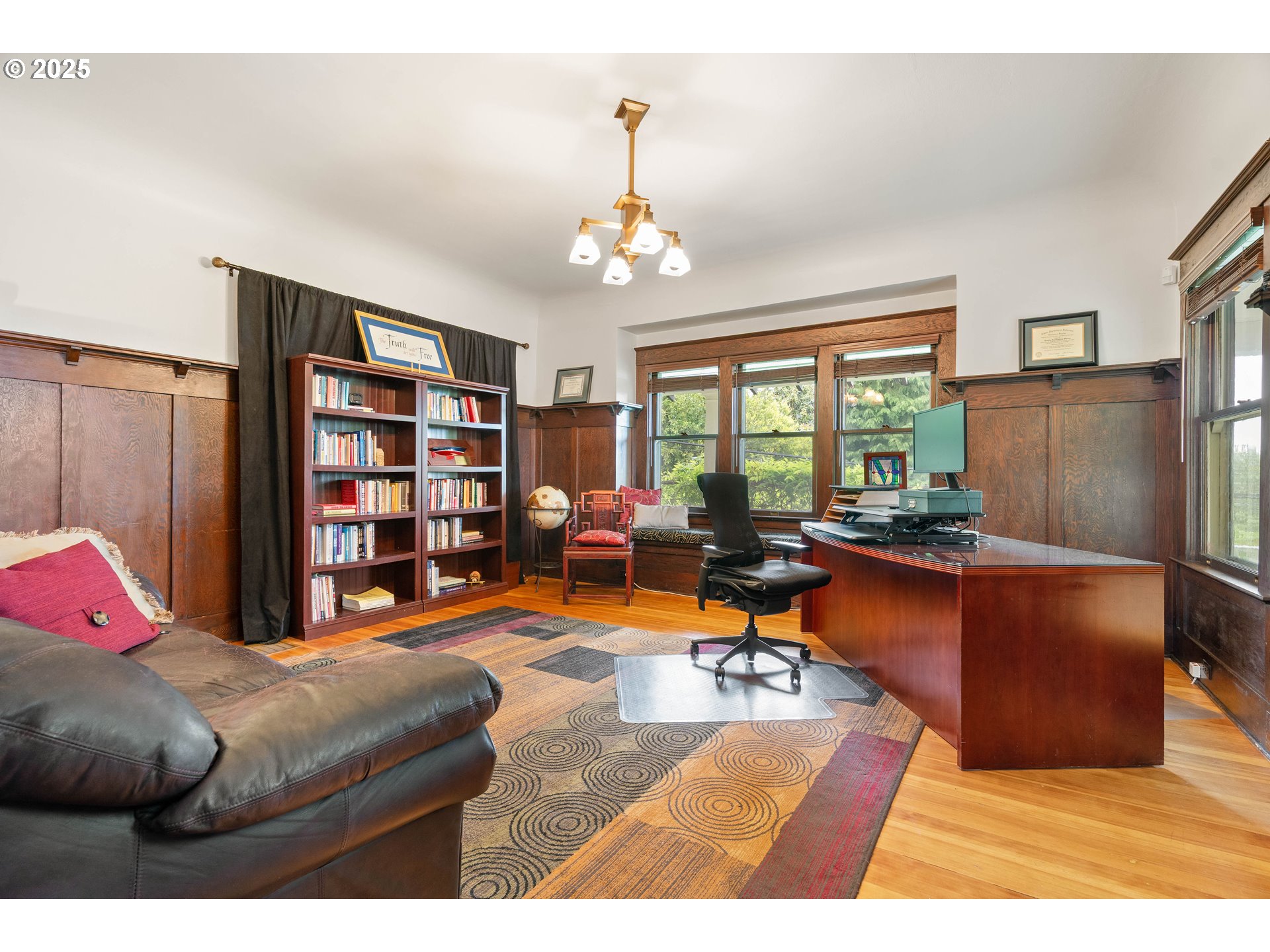 3906 South Kelly Avenue Portland, OR 97239 - Photo 22 of 42 a living room with lots of furniture and a chandelier