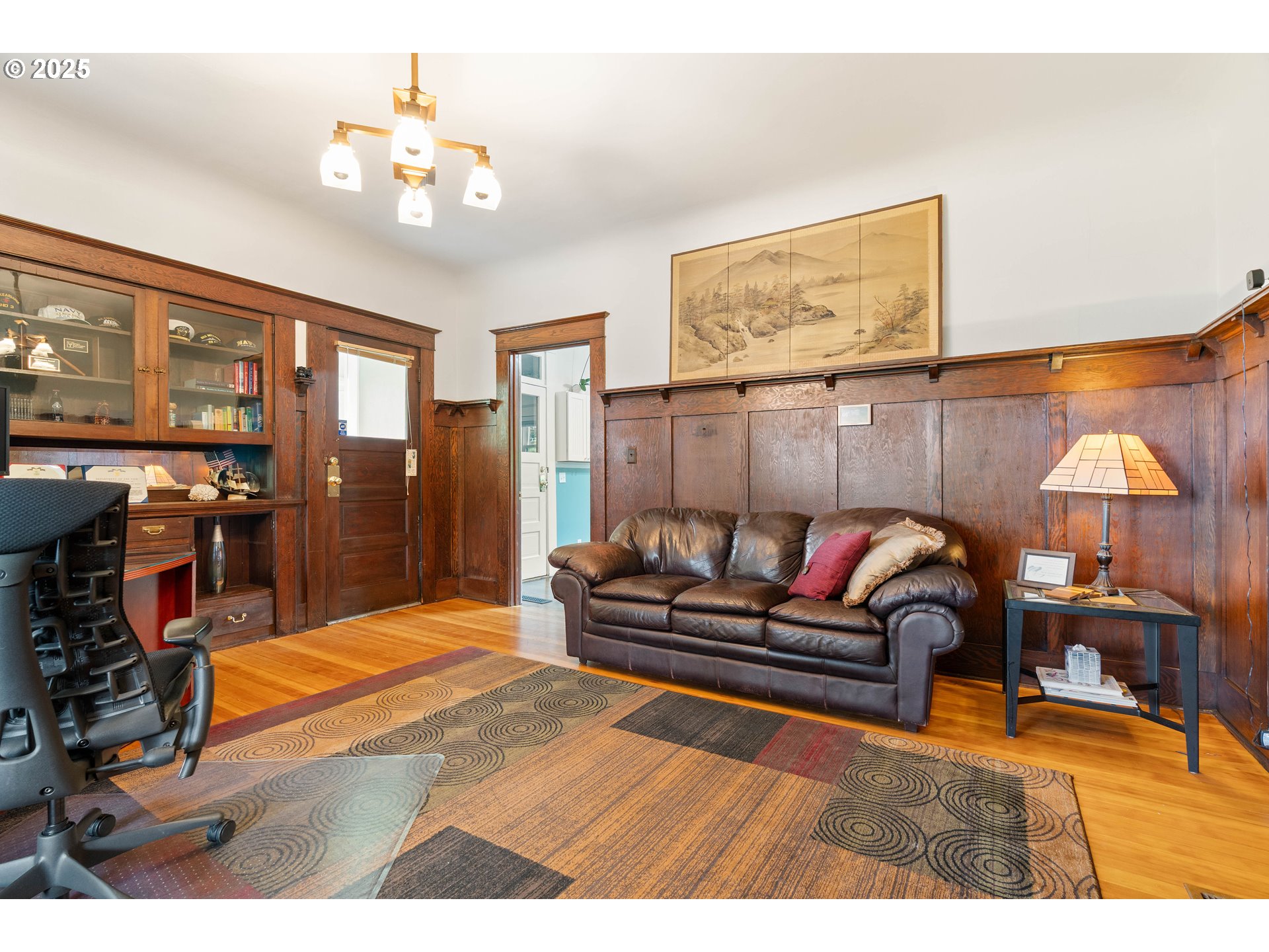 3906 South Kelly Avenue Portland, OR 97239 - Photo 25 of 42 a living room with furniture a chandelier and a dining table