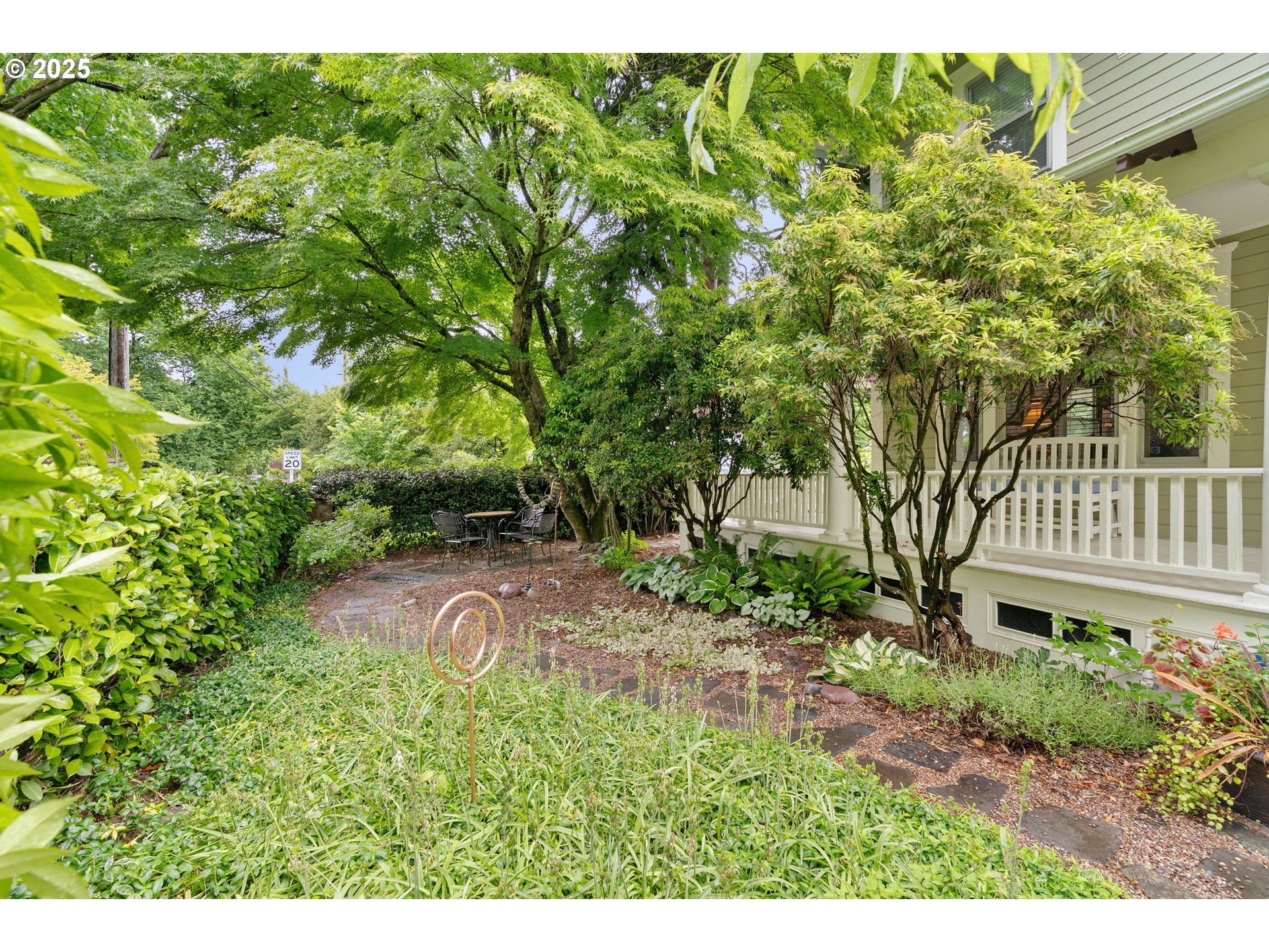 3906 South Kelly Avenue Portland, OR 97239 - Photo 3 of 42 a view of a yard with plants and large trees