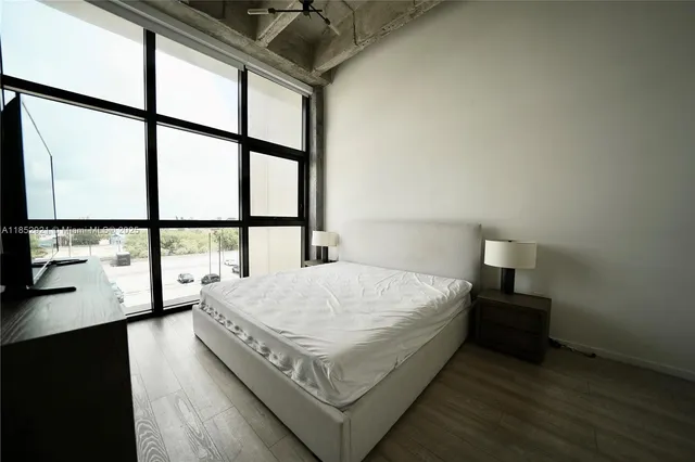 a bed sitting in a bedroom next to a window