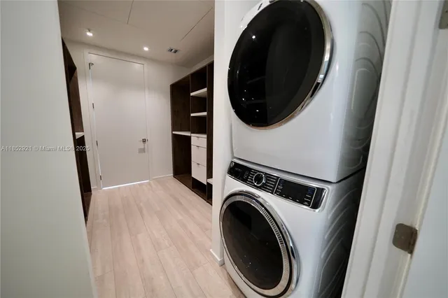 a view of a hallway with washer and dryer