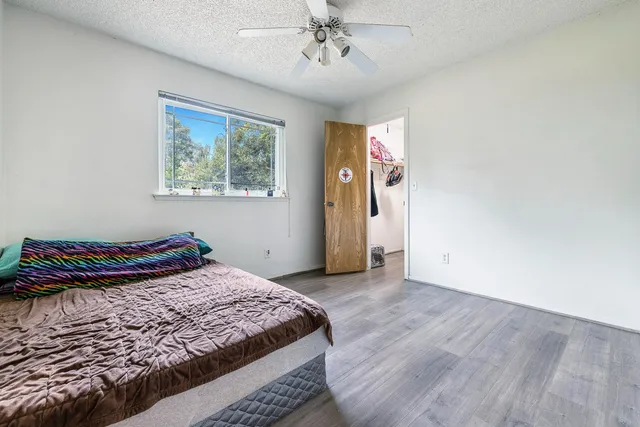 a bedroom with a bed and a window