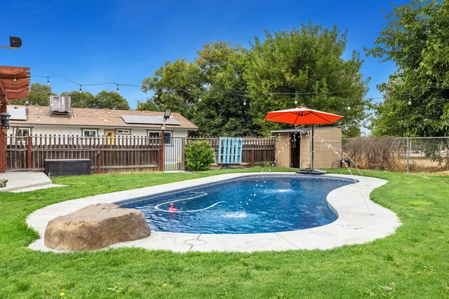 a view of a house with a yard table and chair