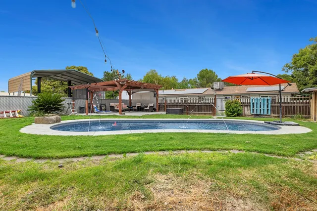 a front view of house with yard and outdoor seating