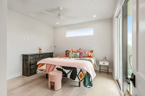 a bedroom with furniture and a large window