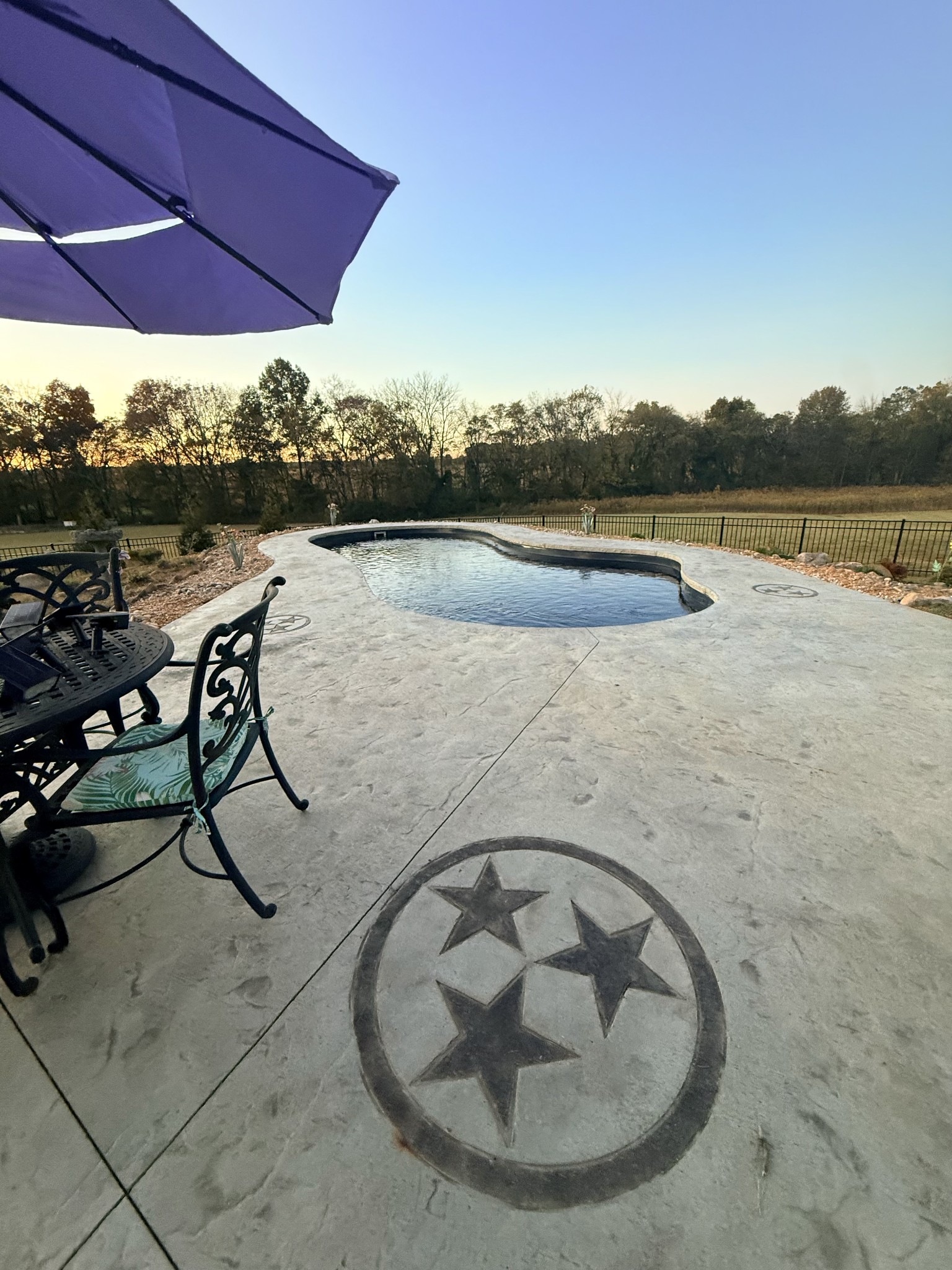 3378 New Hall Road Greenbrier, TN 37073 - Photo 19 of 67 a view of a lake with a table and chairs under an umbrella