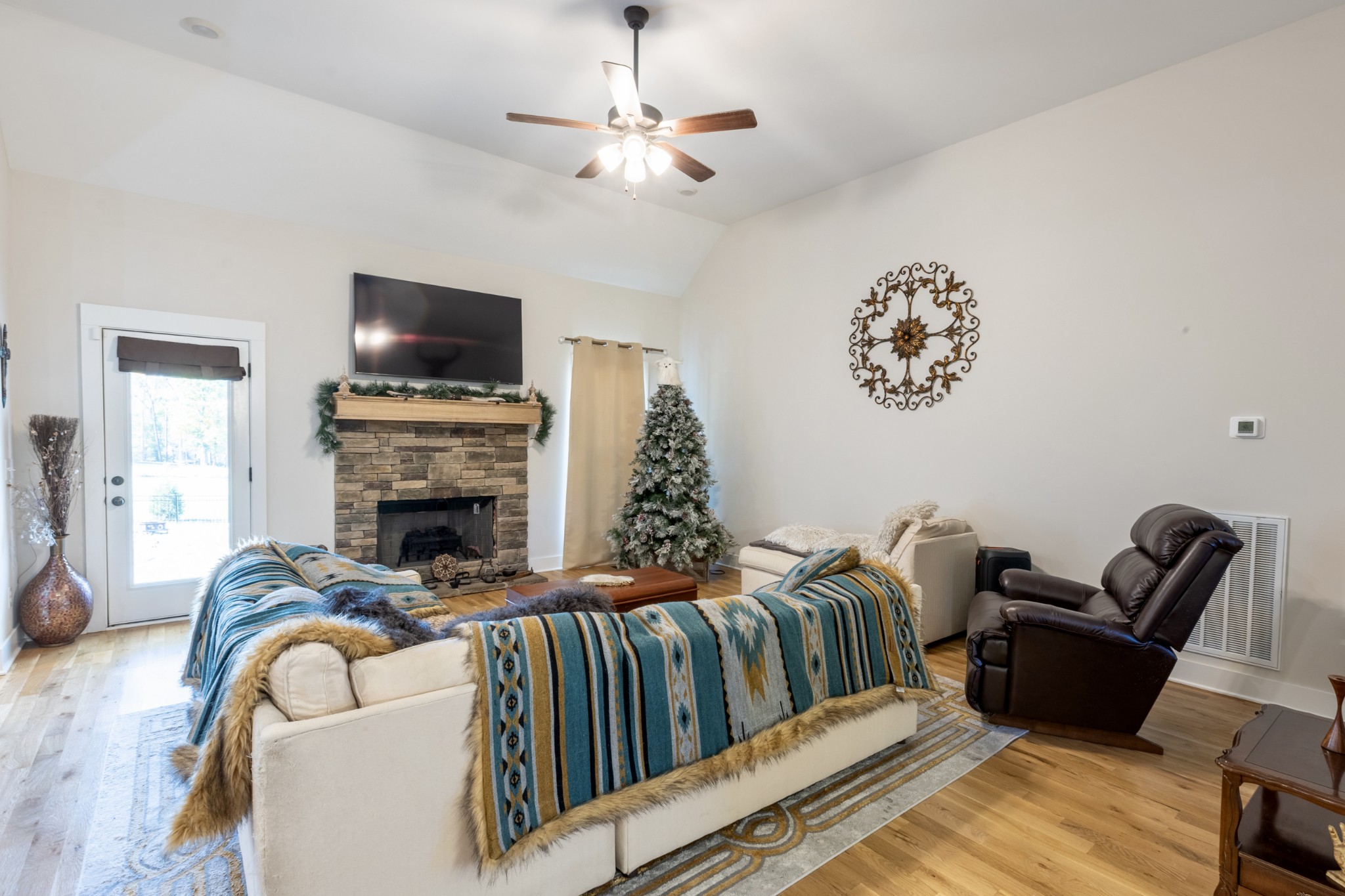 3378 New Hall Road Greenbrier, TN 37073 - Photo 23 of 67 a living room with furniture a flat screen tv and a fireplace