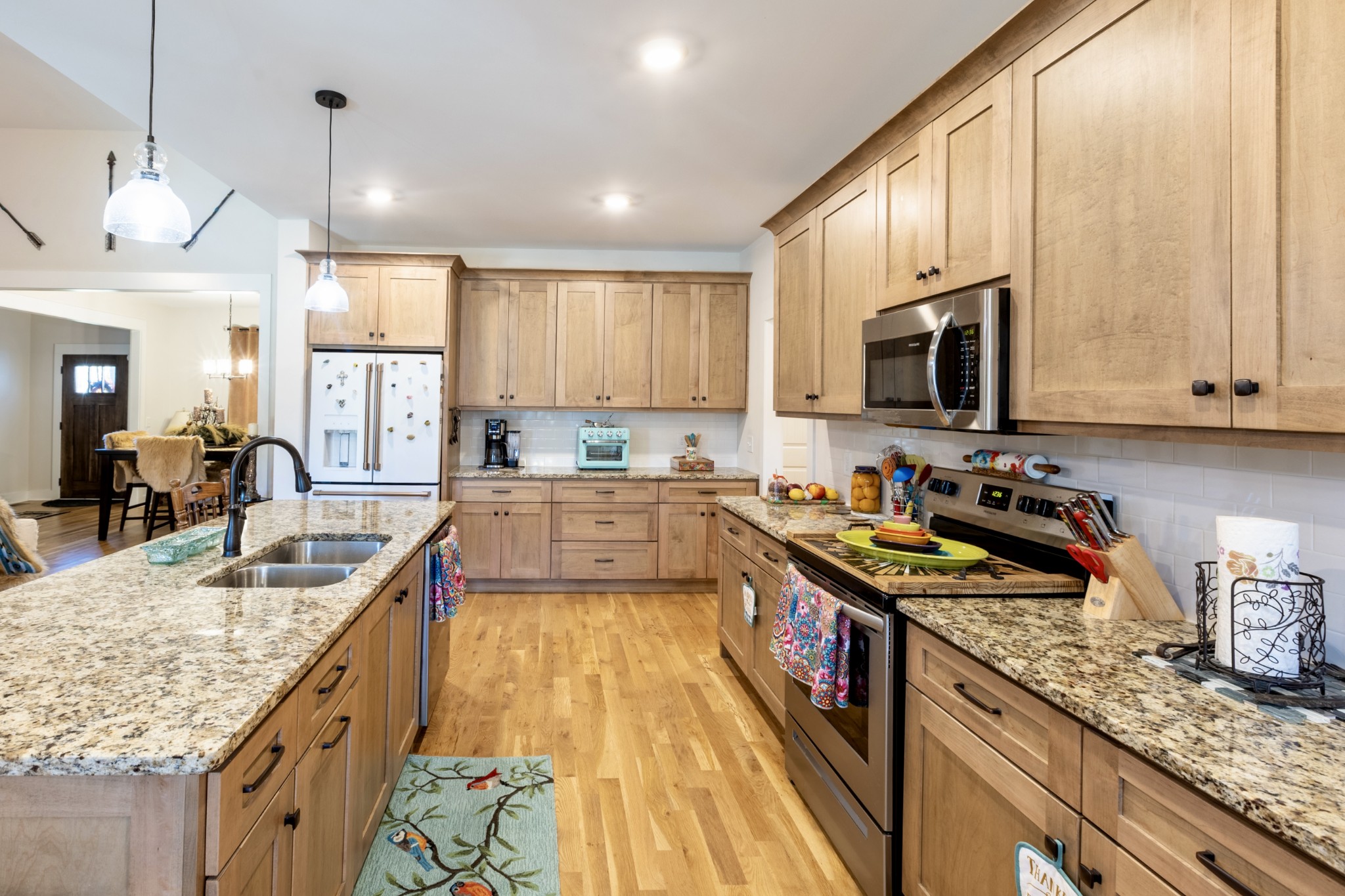 3378 New Hall Road Greenbrier, TN 37073 - Photo 29 of 67 a kitchen with kitchen island granite countertop a sink counter top space appliances and cabinets