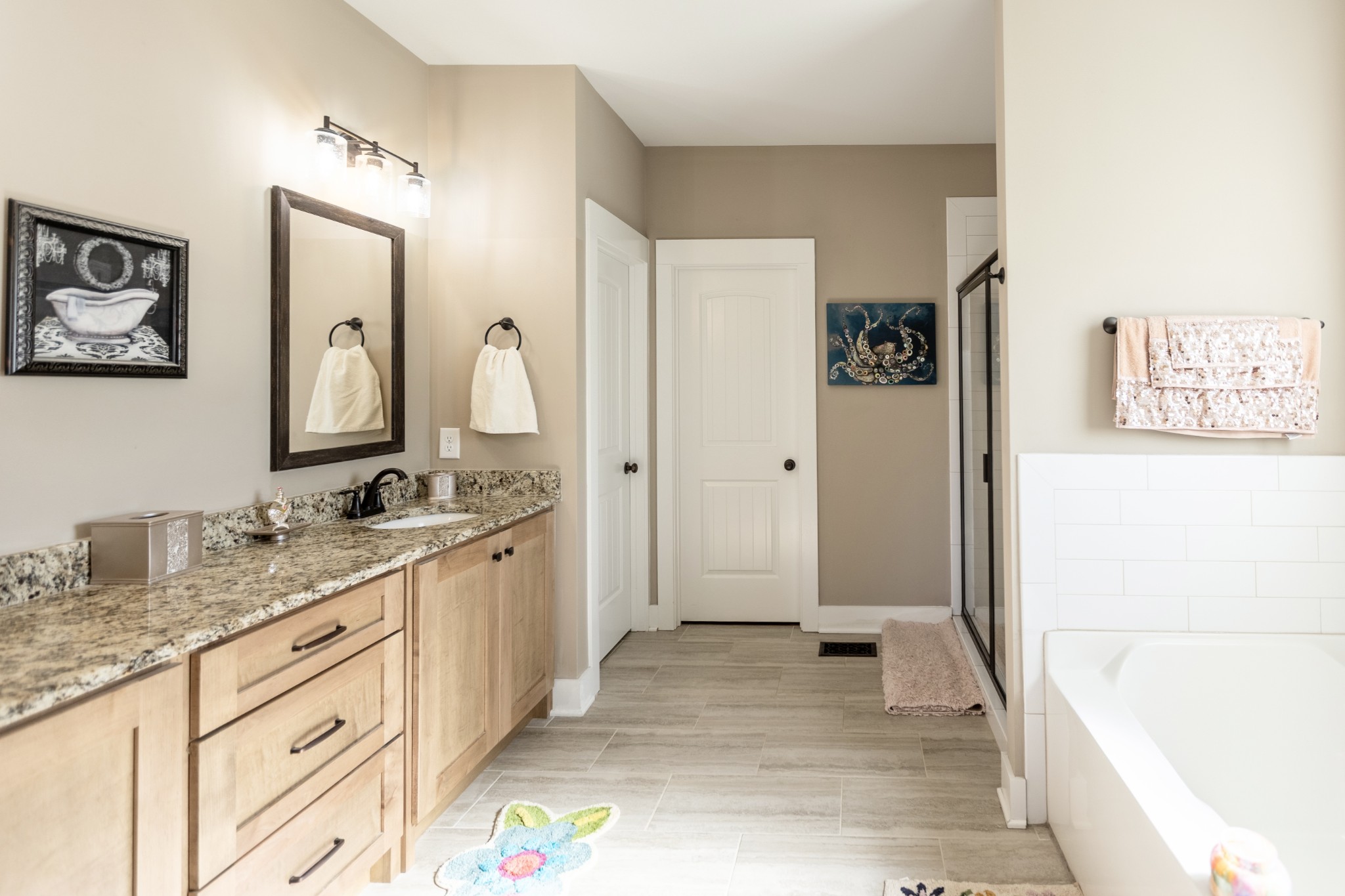 3378 New Hall Road Greenbrier, TN 37073 - Photo 36 of 67 a spacious bathroom with a granite countertop tub sink and mirror