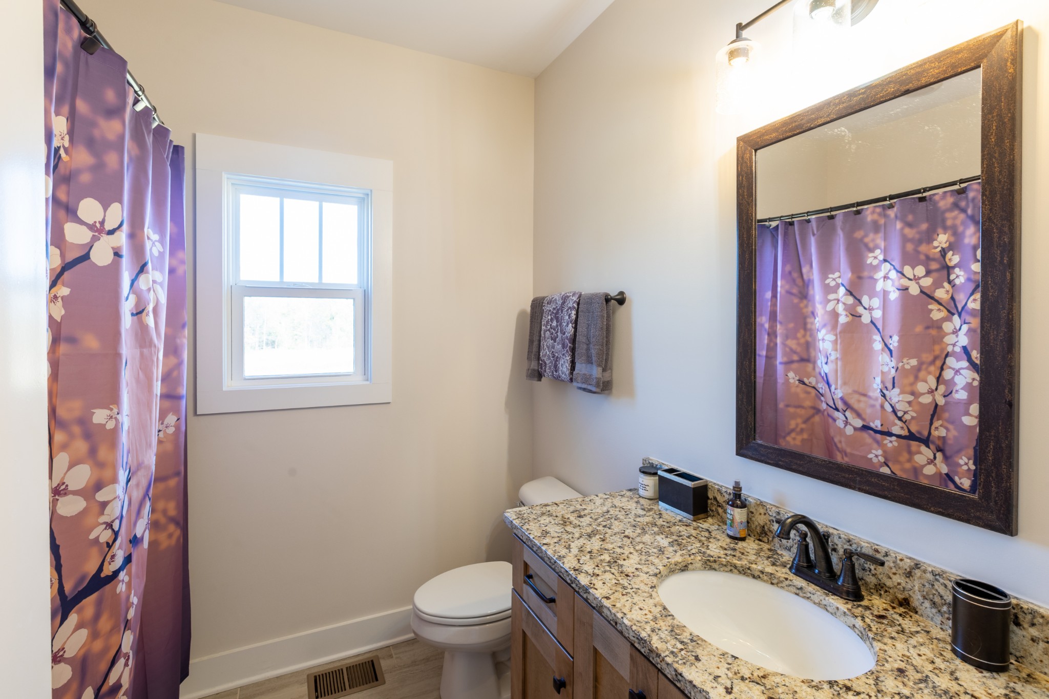 3378 New Hall Road Greenbrier, TN 37073 - Photo 41 of 67 a bathroom with a granite countertop toilet a sink and a mirror