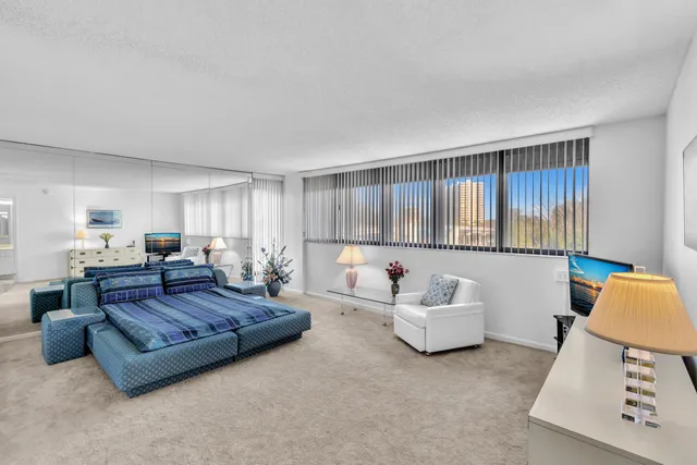 a living room with furniture and kitchen view