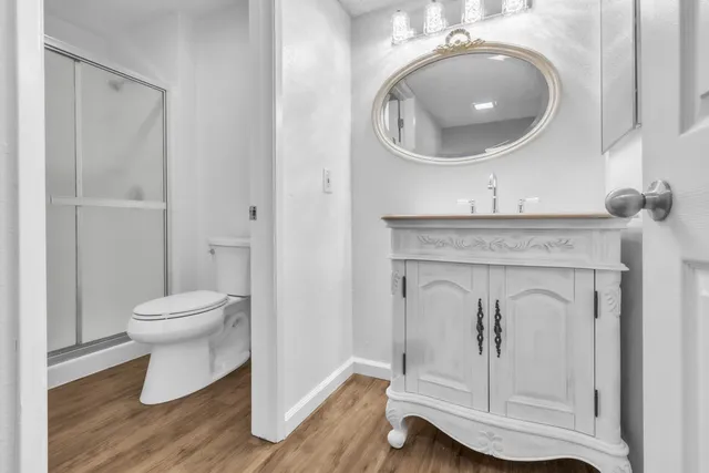 a bathroom with a toilet a sink and mirror