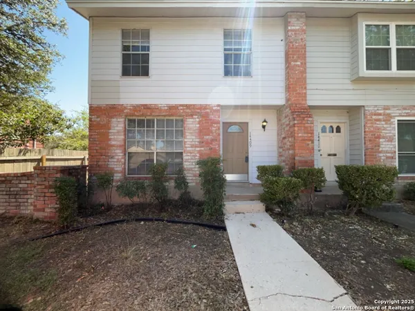 a view of a brick house with a yard