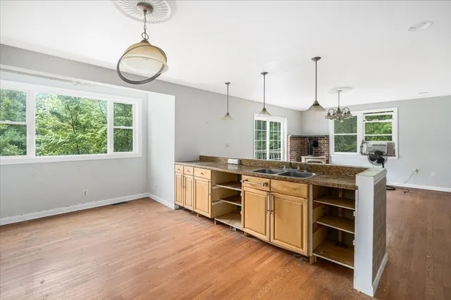 a kitchen with stainless steel appliances granite countertop a stove and cabinets